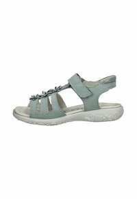 Sandalini blu chiaro realizzati in materiale morbido con numerose aperture. Presentano dettagli metallici decorativi e una suola in gomma bianca per una buona aderenza.