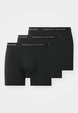 Zwarte boxershorts in een verpakking van drie, gemaakt van zachte stof, met een gebrandmerkte elastische tailleband met "TOMMY HILFIGER" in witte letters.