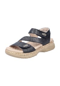 Sandale en cuir noir avec une semelle texturée, dotée de deux sangles réglables et d'accents en métal doré. Semelle intérieure légère et rembourrée pour le confort.