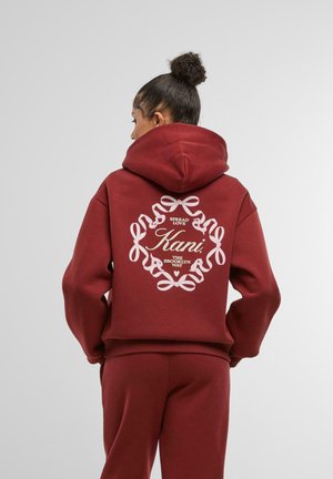 Maroon hoodie made from cotton blend, featuring a large white graphic design with ribbons and text on the back. Ribbed cuffs and hem.