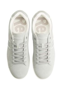 Gray suede sneakers with a white rubber sole and laces. "REDSKINS" branding on the tongue and side, featuring a simple, clean design.