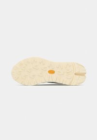 Light gray outsole with deep, multi-directional treads. Vibram logo in orange near the center. Smooth texture with robust design.