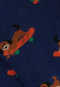 Navy blue socks featuring a knitted pattern of dogs skateboarding on orange boards with green wheels. Soft texture with intricate detailing.