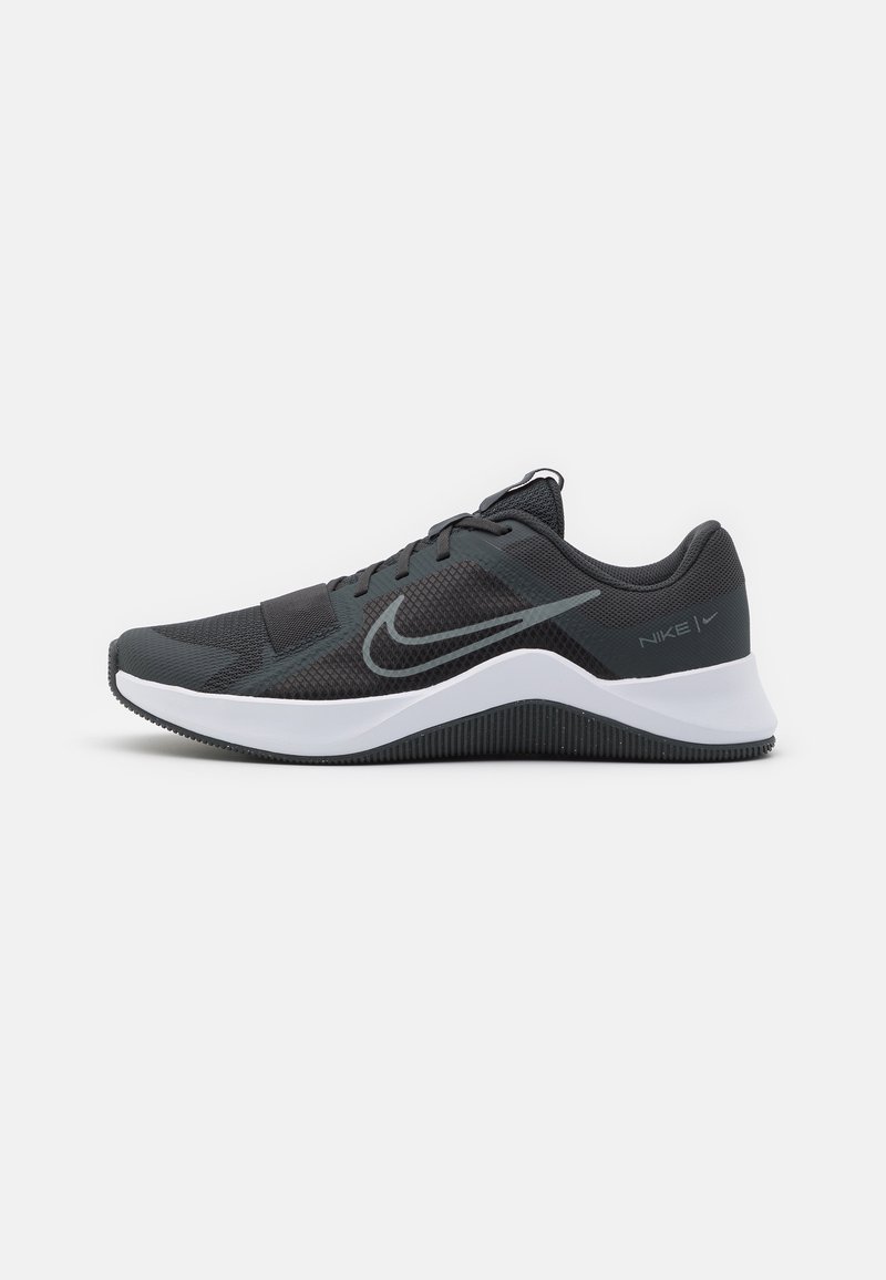 Black athletic shoe with textured mesh upper, white midsole, and grey accents. Features lacing system and cushioned heel for support.