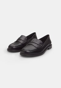 Black leather loafers with two horizontal bands across the vamp, stitched detail, low heel, and smooth texture.