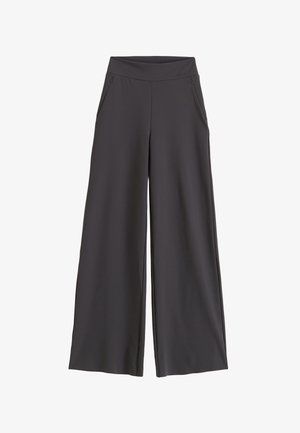 Czarne spodnie o szerokich nogawkach z zamykanymi na zamek kieszeniami bocznymi i wysokim paskiem, zaprojektowane dla luźnego, wygodnego dopasowania.