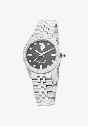 Orologio da polso in metallo argentato con quadrante nero, indicatori in diamante e lunetta zigrinata. Dotato di bracciale in acciaio inossidabile e corona.