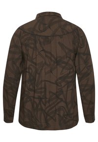 Long-sleeve shirt in brown fabric, featuring a black abstract swirl pattern, button cuffs, and a classic collar at the back.