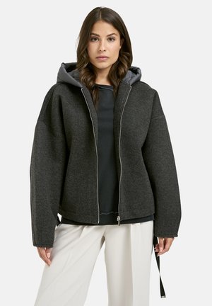 Dark gray cropped jacket with a hood, textured fabric, zip closure, contrasting inner lining, and loose-fit design.