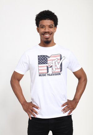 White cotton T-shirt featuring a large MTV logo with an American flag design, black text reading "MUSIC TELEVISION," crew neck style, short sleeves.