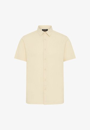 Short-sleeve shirt in light beige fabric, featuring a button-up front, pointed collar, and a smooth texture. No visible patterns or accents.