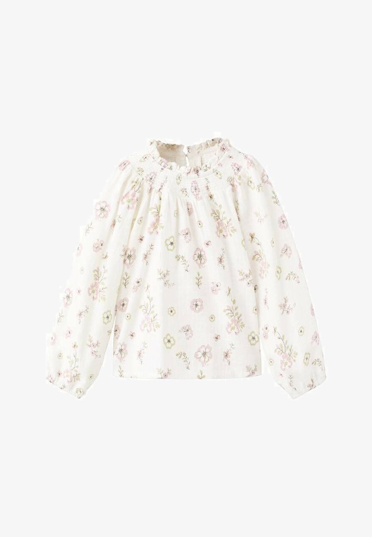 Bela bluza z dolgimi rokavi, okroglim izrezom in nabranim smokom. Celotno bluzo krasi cvetlični vzorec v rožnatih in zelenih tonih.