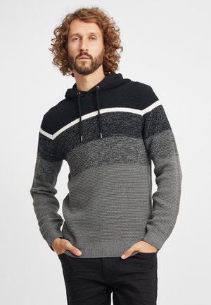 Knitted hoodie featuring a gradient design in black, gray, and white with a textured finish. Includes a drawstring and ribbed cuffs.