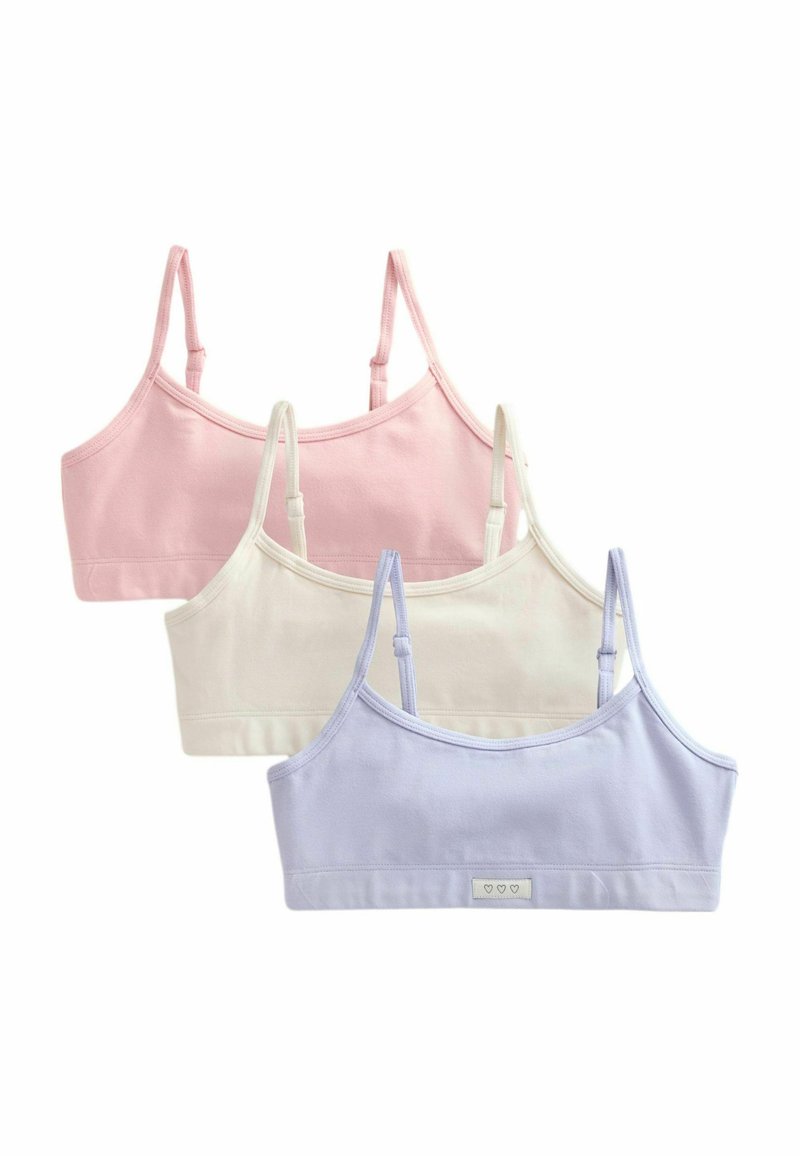 Tre bralette in cotone rosa, bianco e lilla; presentano spalline regolabili e un piccolo tag con logo con icone a cuore sul davanti.