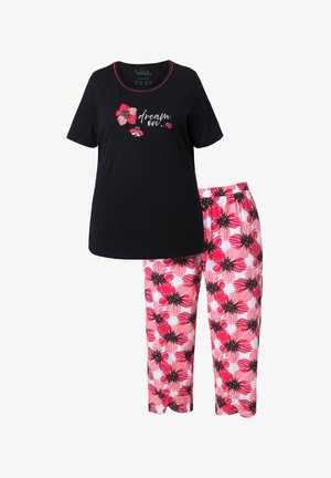 Schwarzes kurzärmliges Oberteil mit pinkem Blumen- und Marienkäfermotiv sowie dem Schriftzug "dream on", kombiniert mit weißen Hosen mit großem pinkem Blumenmuster.