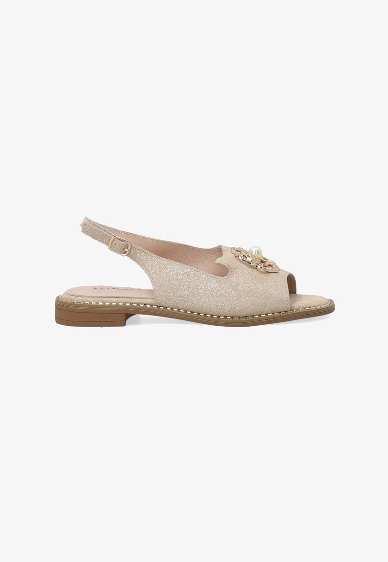 Beige slingback sandal featuring a glittery upper, open toe design, decorative pearl and chain accent, and a low, flat heel.