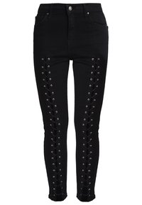 Černé skinny džíny z denimu s bočními šněrovacími detaily a kovovými očky, vysokým pasem a přiléhavým střihem.