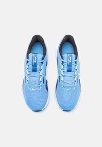Light blue athletic shoes made of mesh material, featuring blue laces, a black lining, and a white sole. The design includes a logo on the tongue.