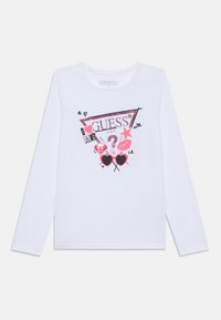 Langärmliges weißes Baumwollhemd mit einem bedruckten Grafikdesign, das pinke und schwarze Elemente umfasst, darunter den Markennamen, Herzen und Sternmotive.