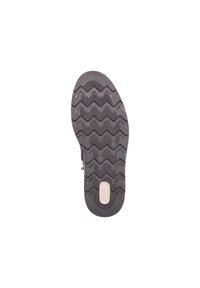 Semelle de chaussure en matériau caoutchouteux gris avec un motif de sculpture en zigzag, surface texturée et un logo central en accent beige clair.