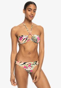 Bikini set featuring a floral pattern with pink, green, and black hues. The top has a bandeau style with a central ring detail.
