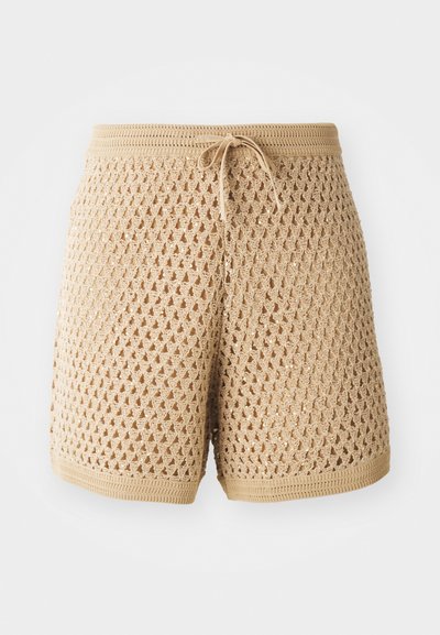 Beige crochet shorts with an intricate diamond pattern, drawstring waist, and ribbed edges. Lightweight and breathable fabric.