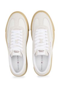 White leather and suede sneakers with cream accents, flat white laces, padded collar, and rubber gum sole. Logo on tongue and side.
