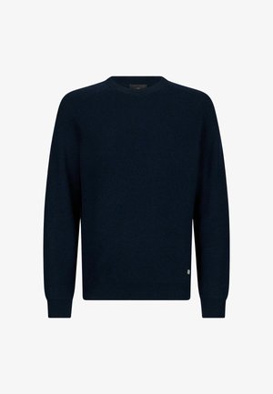 Navy blue knitted sweater with a round neckline, ribbed texture, long sleeves, and a small fabric tag at the bottom left hem.