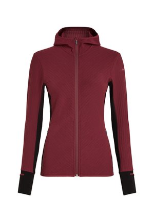 Burgundy zip-up hoodie med strukturerad väv, svarta sidopaneler och en hög krage. Har långa ärmar och tumhål vid manschetterna.