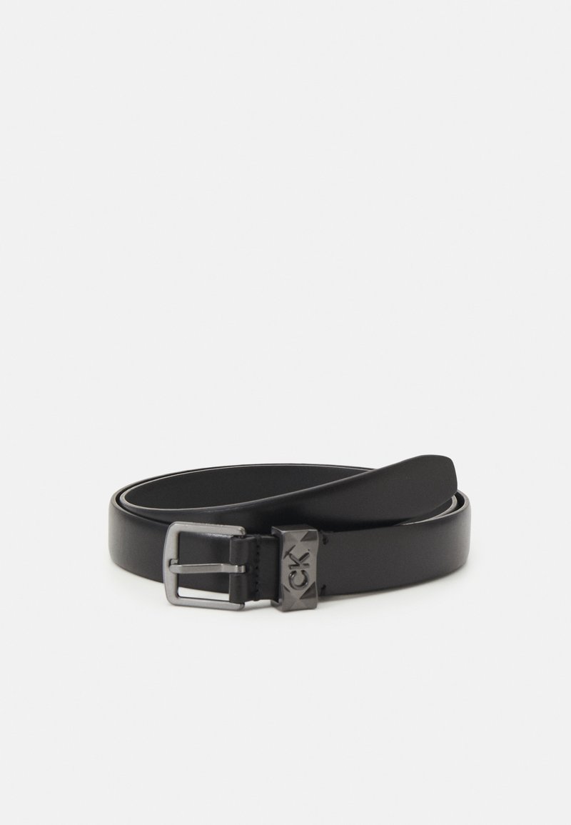 Ceinture en cuir noir enroulée avec une boucle en métal foncé et une boucle métallique cloutée marquée des initiales "CK".
