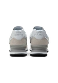 Gray New Balance sneakers with suede and leather uppers, featuring a white midsole, black rubber outsole, and "New Balance" logo on the heel.