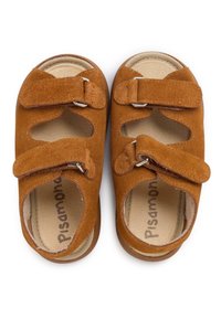 Brown suede sandals with two adjustable Velcro straps, open sides, and a cushioned insole. Brand name "Pisamonas" printed inside.