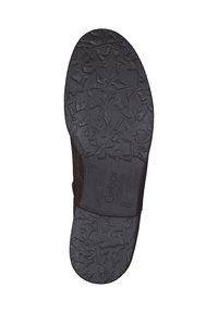 Brown shoe sole with textured black rubber for grip. Features embossed branding and a smooth, curved edge. Pattern resembles irregular shapes.