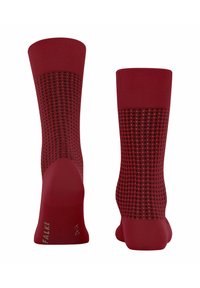 Rote Sportstrümpfe mit geripptem Bündchen, gepunkteten Mesh-Einsätzen für Atmungsaktivität und verstärkten Zehen und Fersen. Mit Logo der Marke an der Seite.