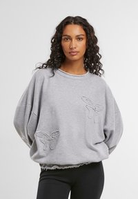 Gray sweatshirt featuring oversized fit, ribbed neckline, and embroidered butterfly designs on the front. Soft fabric with frayed hem.