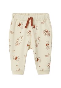 Cremefarbene Sweatpants mit strukturierter Oberfläche, ausgestattet mit einem braunen Kordelzug und einem wiederholten Druck von Charakteren in einem verspielten Design.