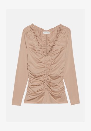 Dolga majica v svetlo bež barvi, s smetanastim dizajnom in nagubanimi ročaji. Gladek, elastičen material s prilegajočo silhueto.