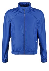Blaue leichte Jacke mit durchgehendem Reißverschluss, Kragen mit Druckknöpfen, Seitentaschen sowie elastischen Bündchen und Saum.