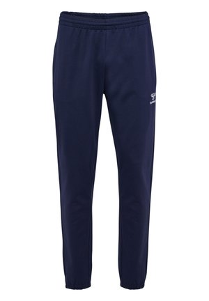 Navy athletic pants made of soft fabric, featuring an elastic waistband, tapered legs, and a small white logo on the left thigh.