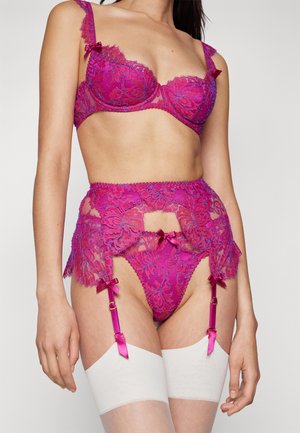 Fuchsia lace bra and garter set with floral patterns, decorative bows, and satin accents. Sheer fabric with cutouts and adjustable straps.