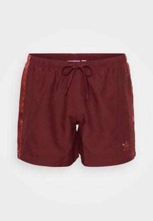 Bordeauxfarbene Badeshorts aus leichtem Material. Elastischer Bund mit Kordelzug. Seitentaschen und Logo-Detail an der unteren Vorderseite.