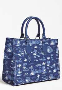 Torebka na ramię z płótna w granatowym kolorze z białymi wzorami graficznymi; posiada skórzane akcenty, podwójne górne uchwyty i usztywniony prostokątny kształt.