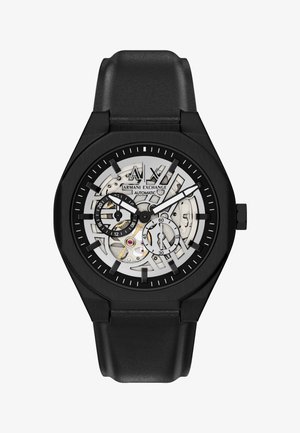 Sort Armani Exchange automatisk armbåndsur med skelet urskive, to underskiver, hvide time- og minutvisere og sort læderrem.