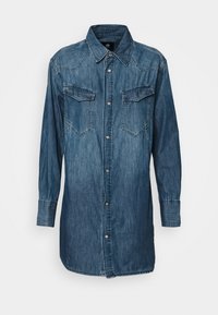 Long-sleeve denim shirt dress with snap buttons, two chest flap pockets, and a pointed collar in a medium blue wash.