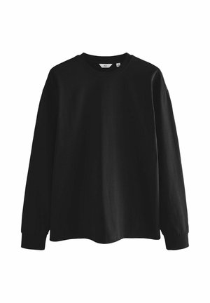 Schwarzes langärmliges T-Shirt aus Baumwolle. Design mit Rundhalsausschnitt und lockerer Passform. Keine sichtbaren Muster oder Akzente. Schlichte und glatte Textur.