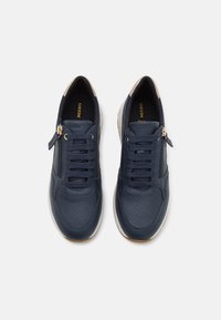Kék bőr sneaker cipők lyukacsos mintával, fűzős elülső résszel és arany cipzár díszítéssel. Krémszíínű gumitalp. Geox márkajelzés látható belül.