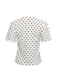 Hvid top med korte ærmer og sorte polkaprikker, der har en rund halsudskæring og tekstureret stof. Skræddersyet pasform med en lige nederste kant.