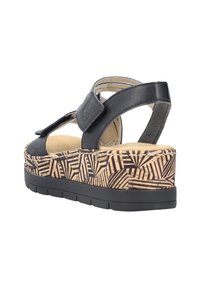 Schwarze Ledersandale mit verstellbarem Riemen, Korkmuster-Plattform und strukturiertem Gummisohle. Rundes Zehen- und offenes Fersen-Design.