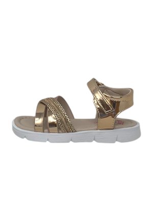 Sandalo aperto per bambino con cinturini metallici dorati e suola bianca flessibile, con chiusura a strappo alla caviglia.