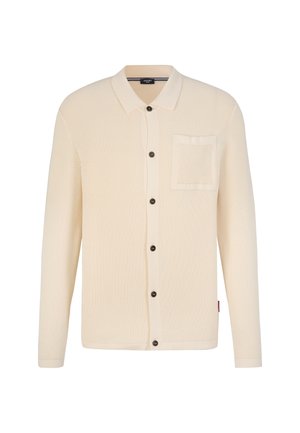 Strickjacke in Creme mit kragenförmigem Ausschnitt, vorderen Knöpfen, Tasche auf der linken Brust und strukturiertem Stoff. Verfügt über dunkle Knöpfe für einen Kontrast.